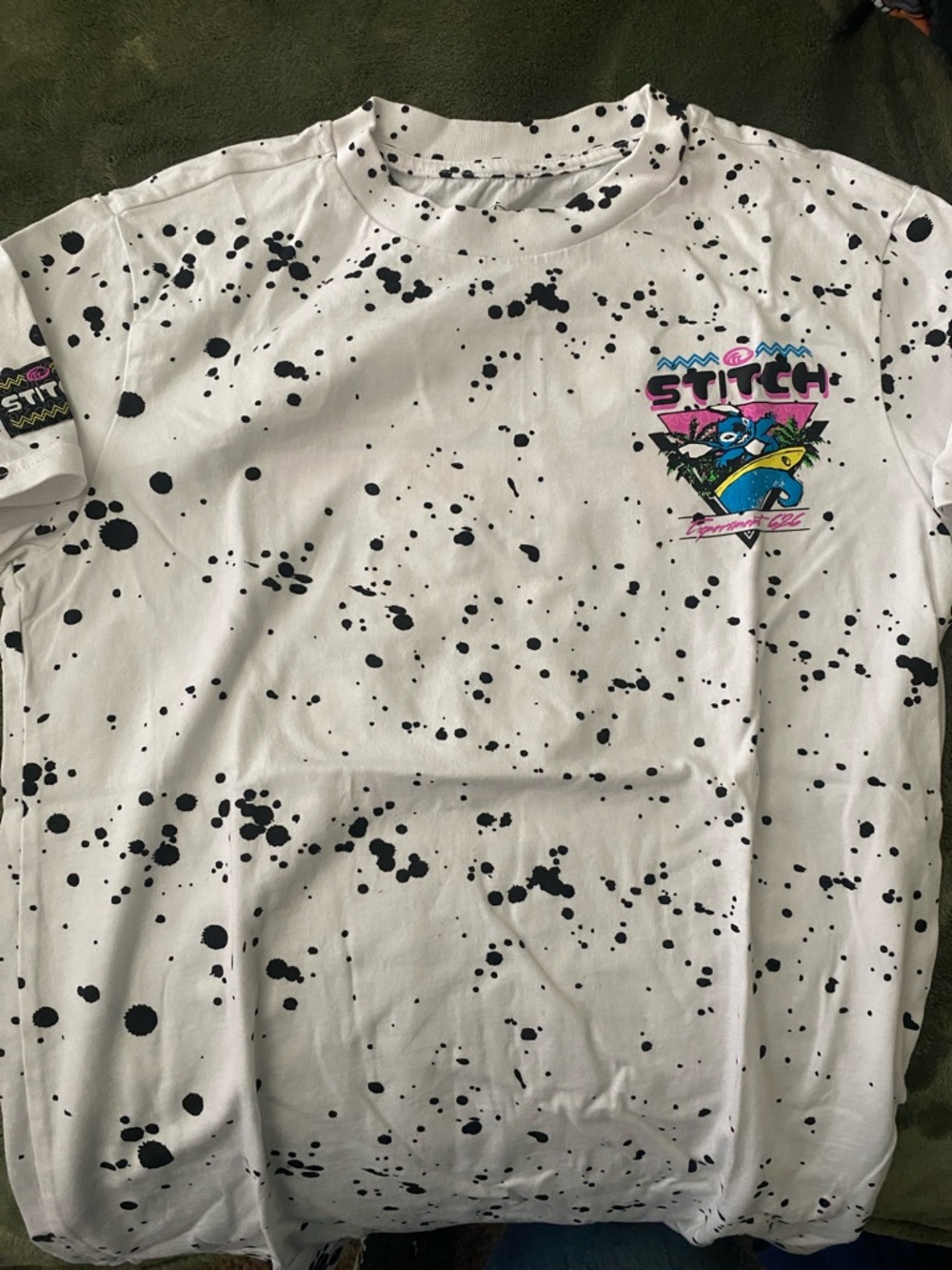 Disney White Tee with Black Splatter and Colorful Stitch Graphic